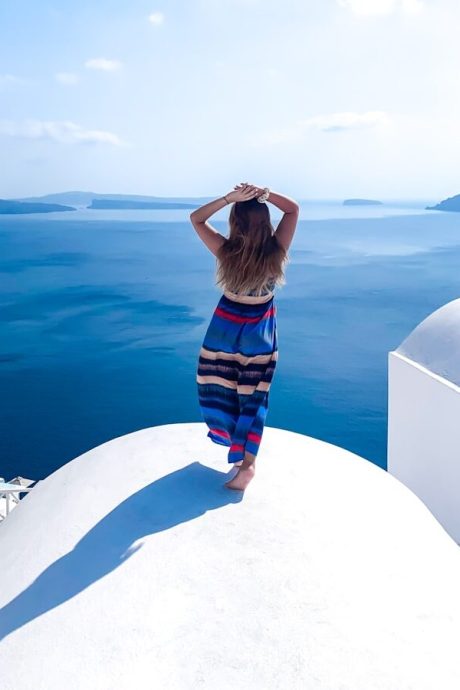 A woman standing on top of a white building